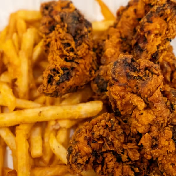 Crispy fried chicken tenders with golden french fries, a popular side dish at Raceway Bagels.